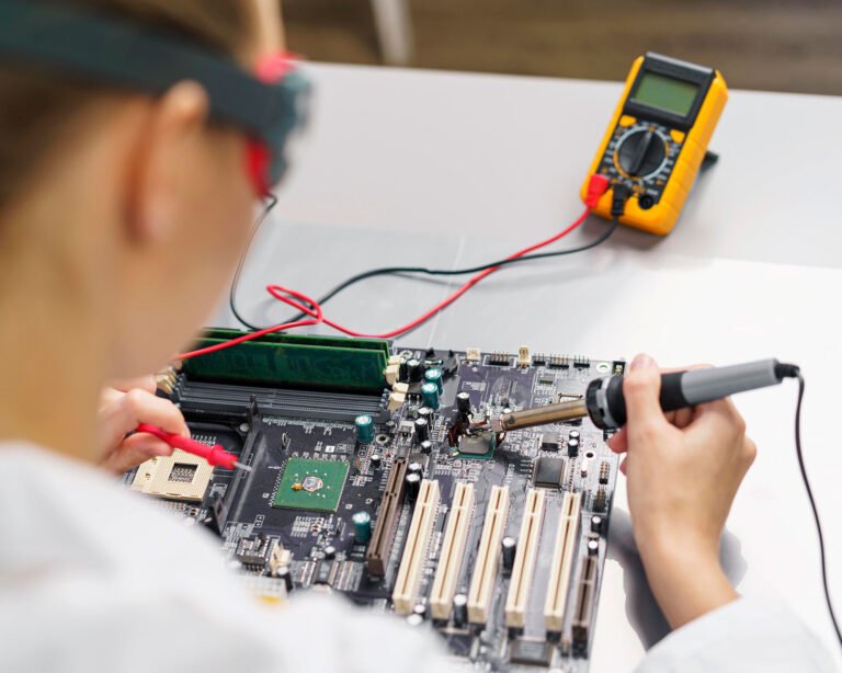 high-angle-female-technician-with-soldering-iron-electronics-motherboard